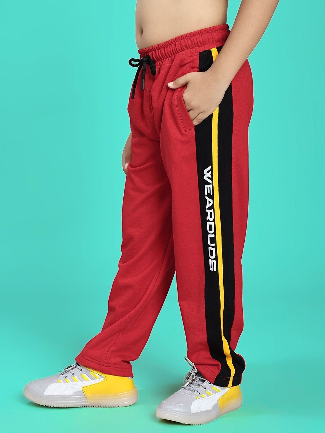 Child wearing ROGER RELAXED-FIT JOGGER FOR BOYS AND GIRLS RED BLACK, stylish casual pants with side stripes and pockets.