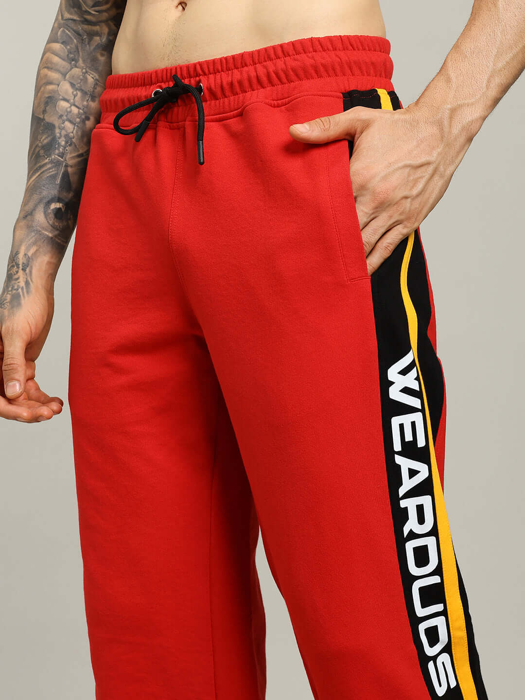Red ROGER RELAXED-FIT JOGGERS MEN by DUDS with side stripe detail.