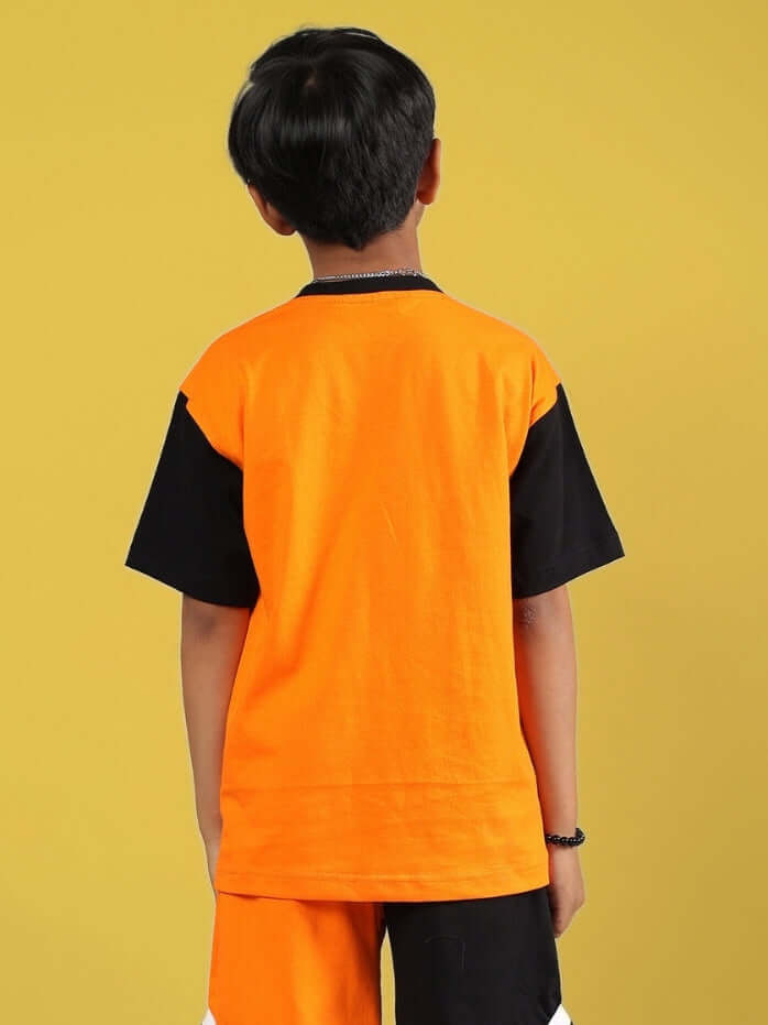 Boy wearing Rogue Rider T-shirt in black and orange, rear view, customizable sizes available, tailored with care.