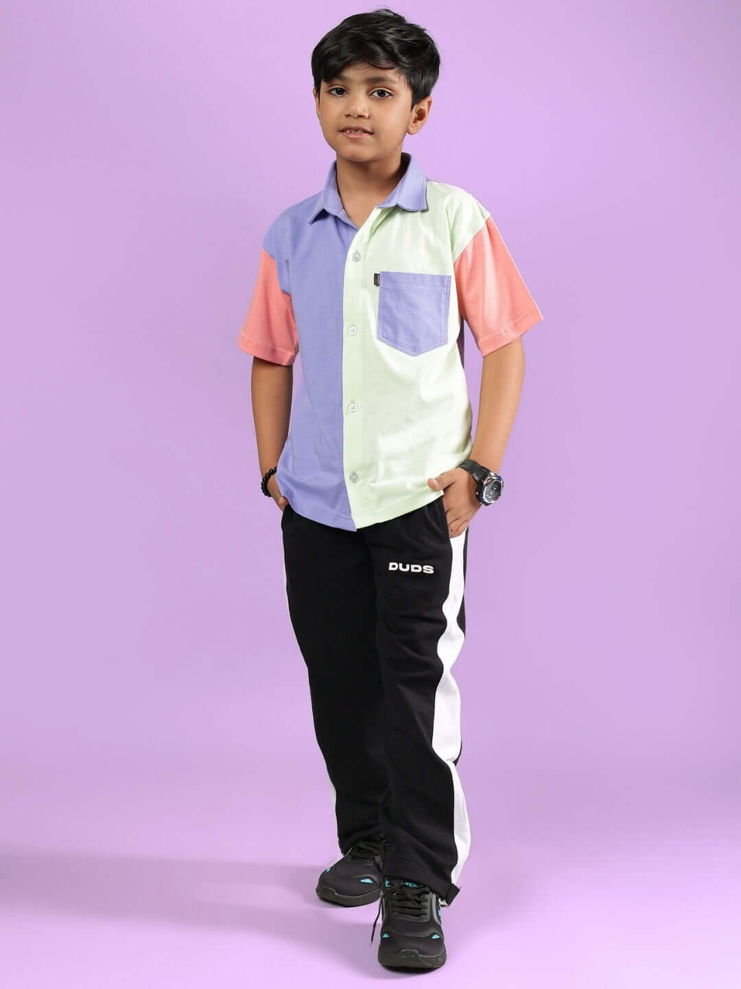 Boy wearing Roman co-ord set in multi-black by DUDS, featuring pastel color-block shirt and black pants with custom fitting option.