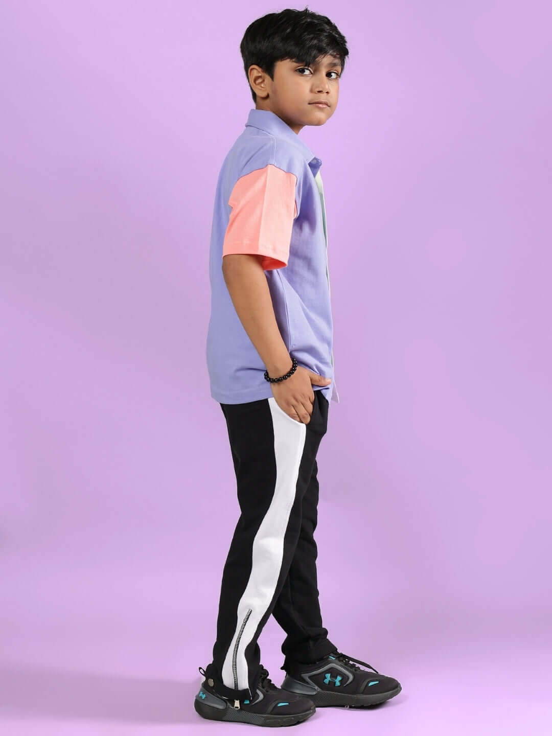 Child wearing ROMAN CO-ORD FOR BOYS & GIRLS MULTI-BLACK, sporty co-ord set with colorful top and black pants, ideal for kids' comfort and style.