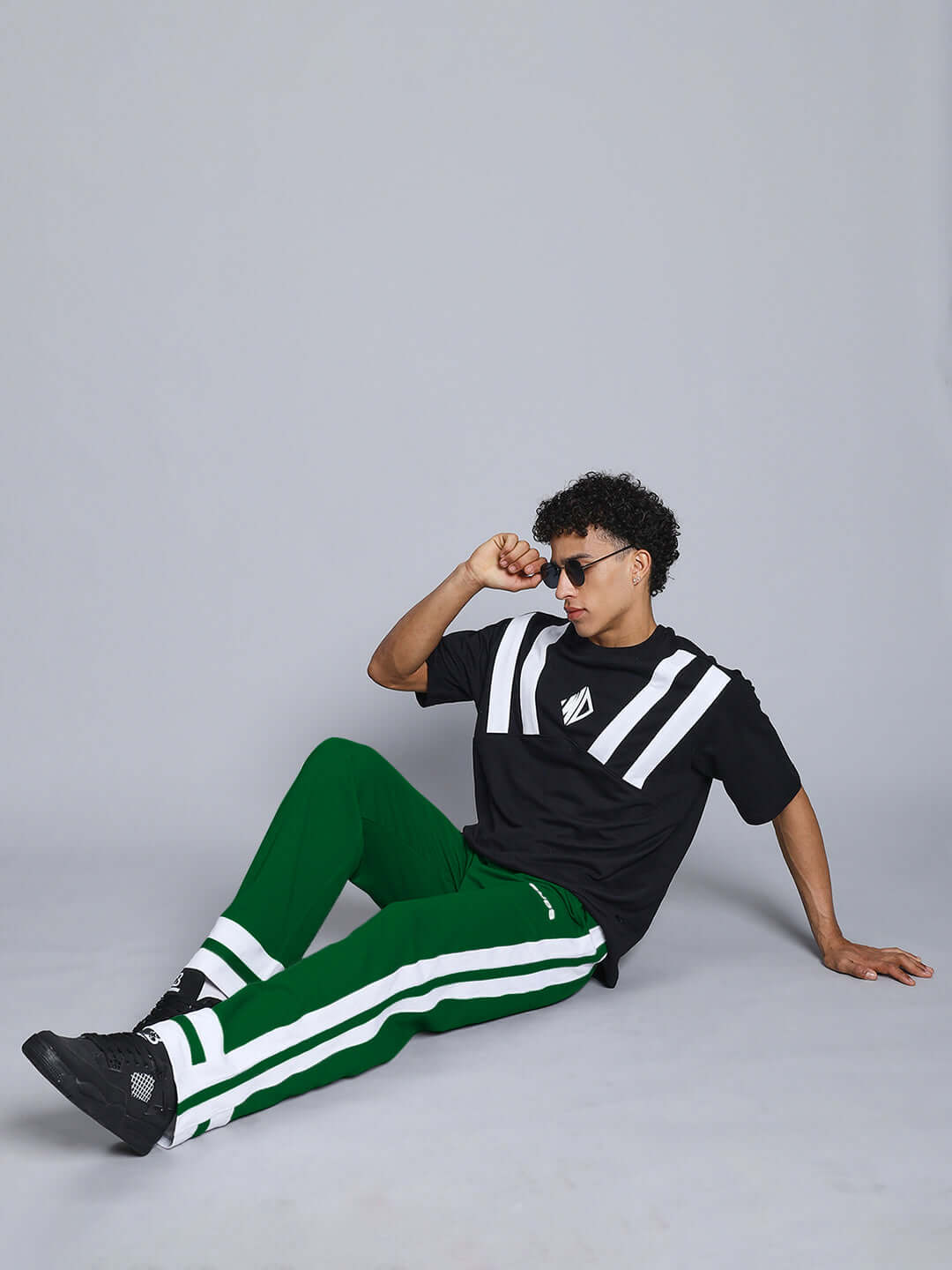 Model wearing green-white Ronny Side Stripe Jogger with black and white shirt, showcasing comfortable, stylish design by DUDS.