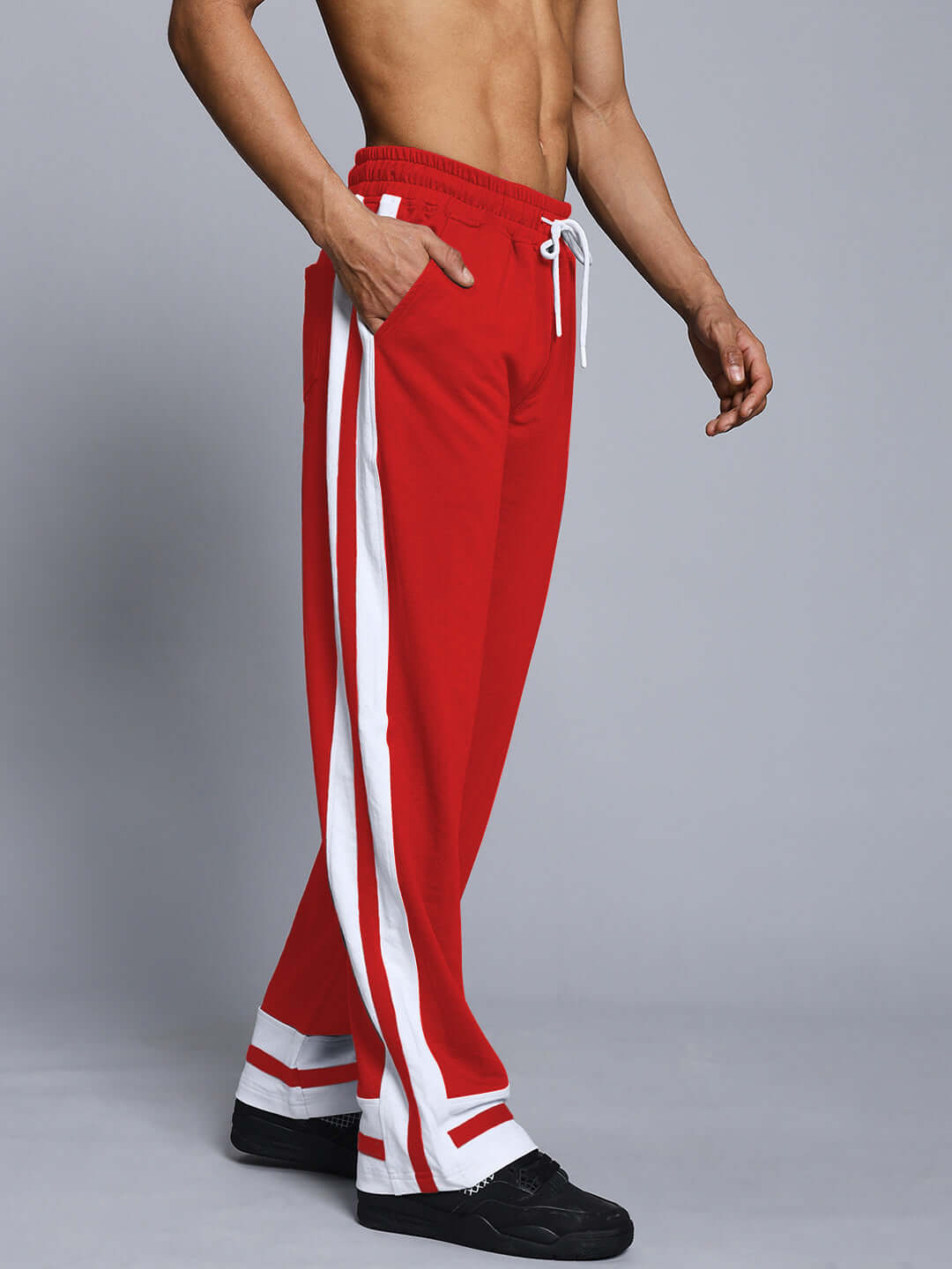 Model wearing RONNY SIDE STRIPE JOGGER in red and white, showcasing custom fit and style by DUDS.