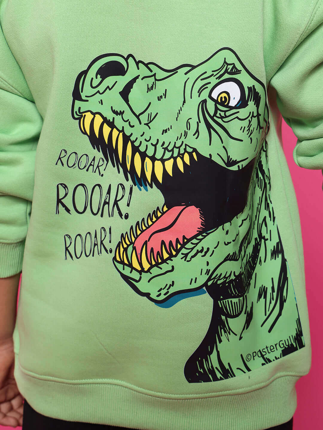 Kids neon green sweatshirt with dinosaur graphic and text 'ROOAR!' on pink background.