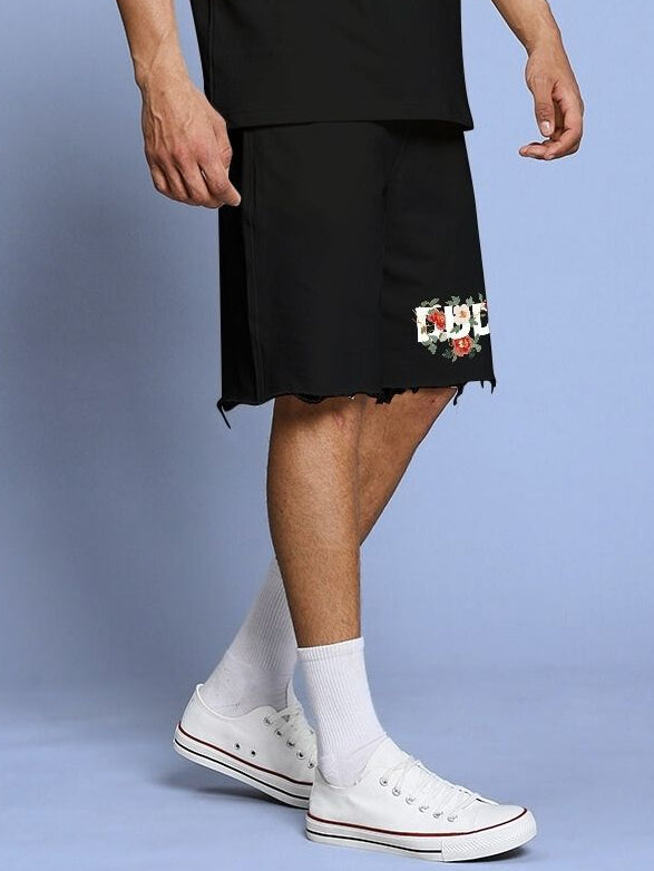 Person wearing ROSE CHARM RELAXED FIT SHORTS BLACK with casual sneakers.