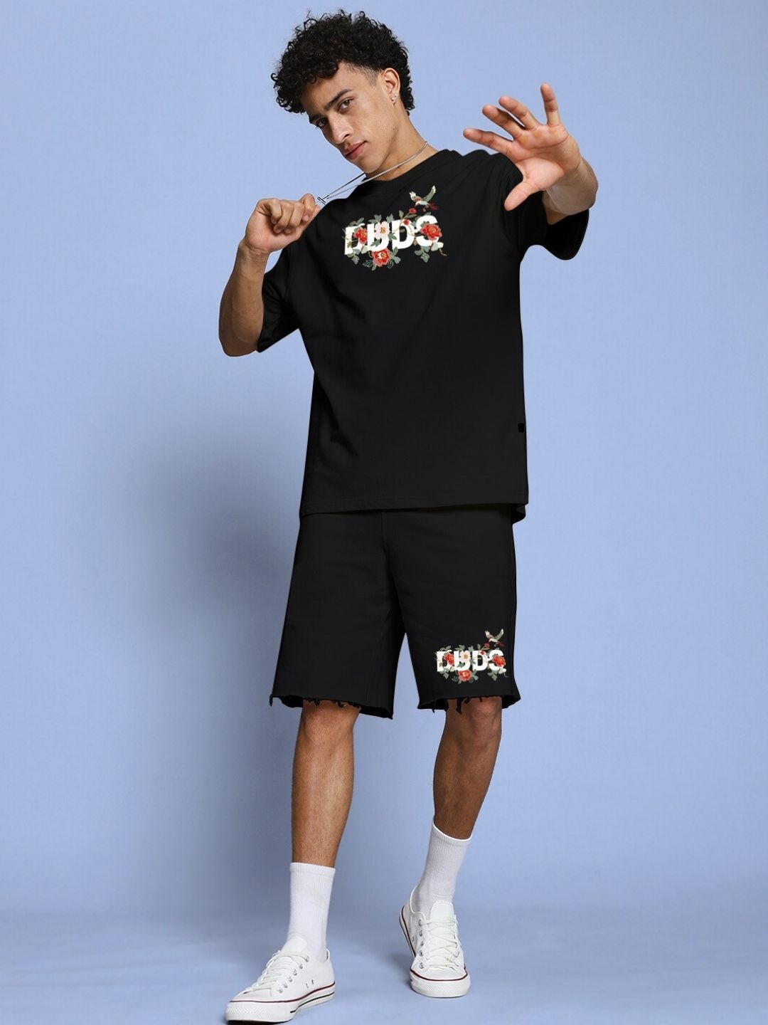 ROSE CHARM RELAXED FIT SHORTS BLACK worn by a person in a casual pose, highlighting comfortable premium fabric and stylish design.