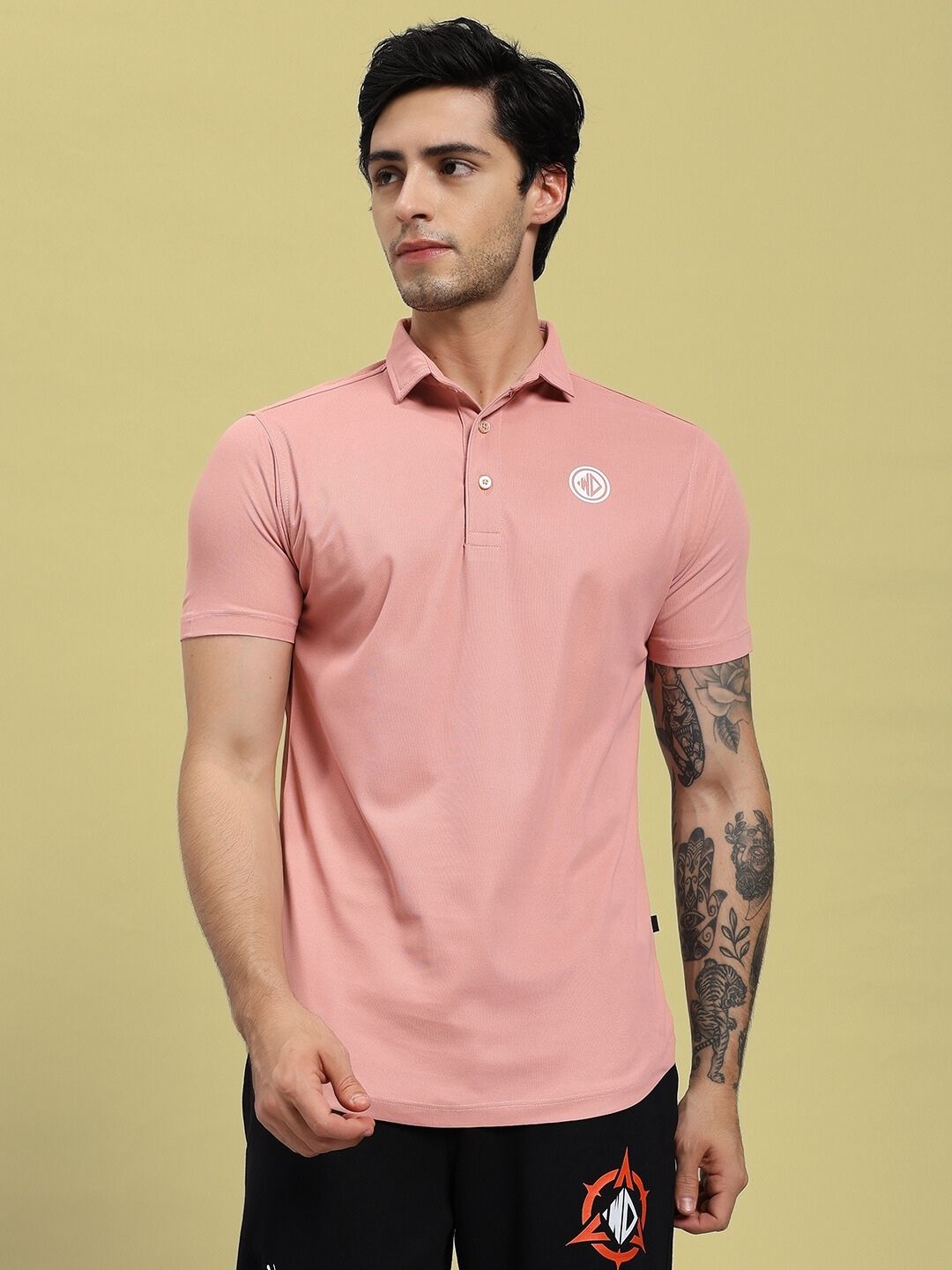 Man wearing ROSEWOOD POLO REGULAR FIT T-SHIRT PINK, showcasing its style and comfort in a casual setting.
