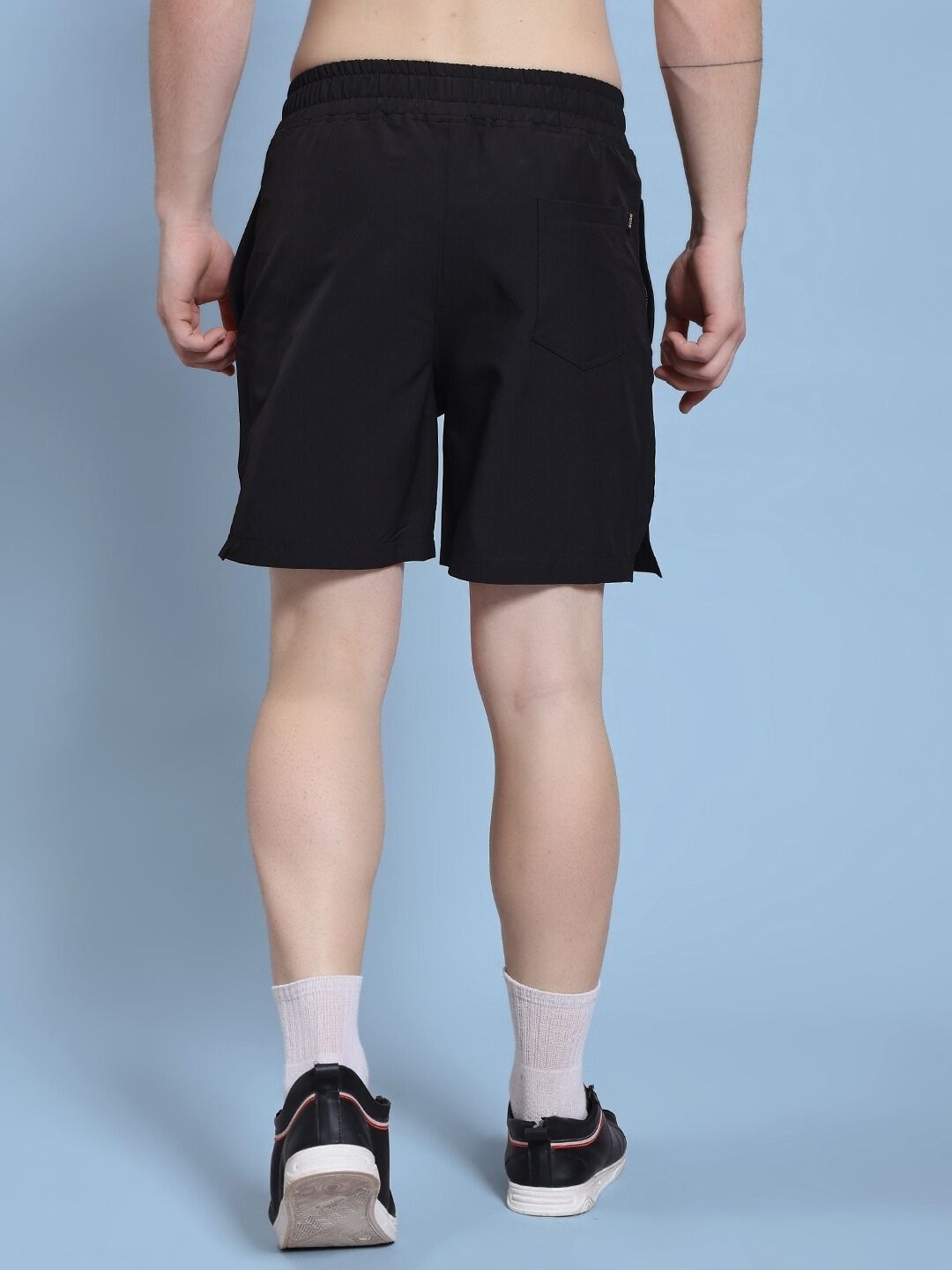 Back view of ROSEWOOD RELAXED FIT SHORTS BLACK highlighting the relaxed silhouette and comfort in movement.