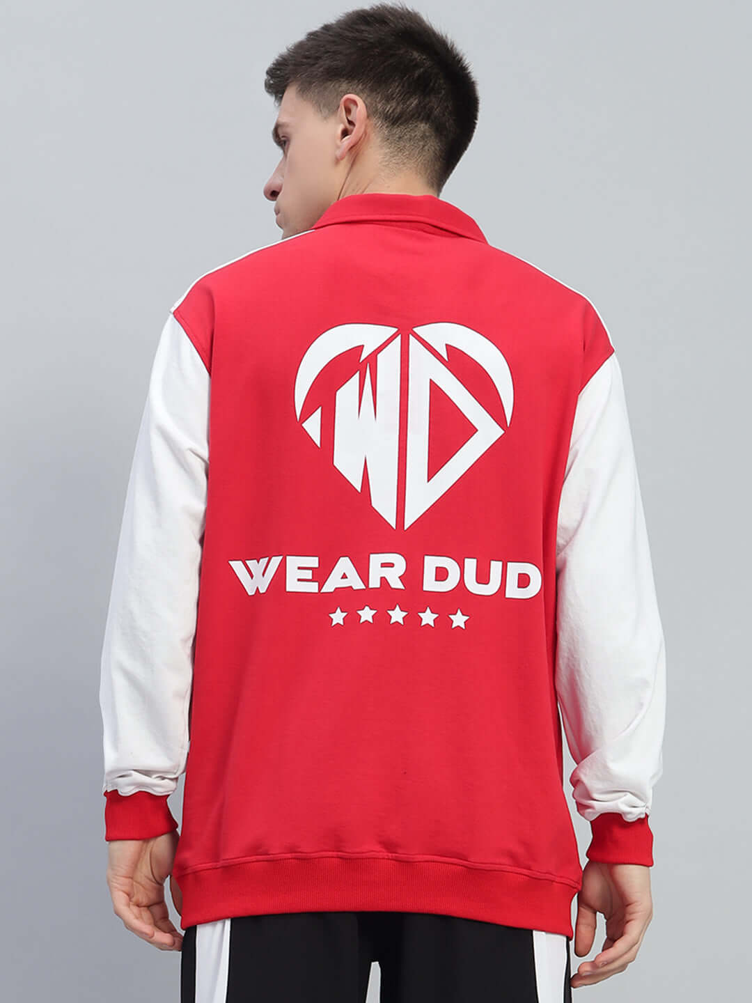 Rear view of model wearing red and white Rowan oversized sweatshirt, featuring a bold graphic design and text "Wear Dud"