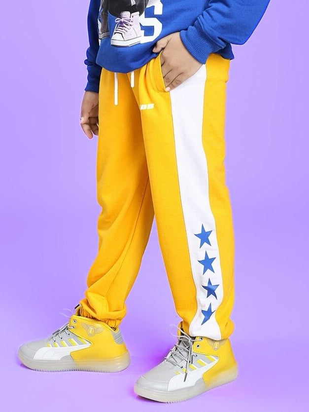 ROX PRIMER JOGGER FOR BOYS AND GIRLS YELLOW WHITE shown with star pattern and sneakers