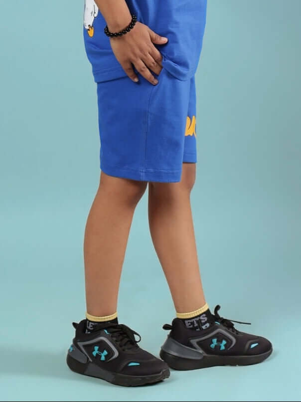 Child wearing GO MOTION SHORTS FOR BOYS & GIRLS ROYAL BLUE showcasing sporty design and comfort.