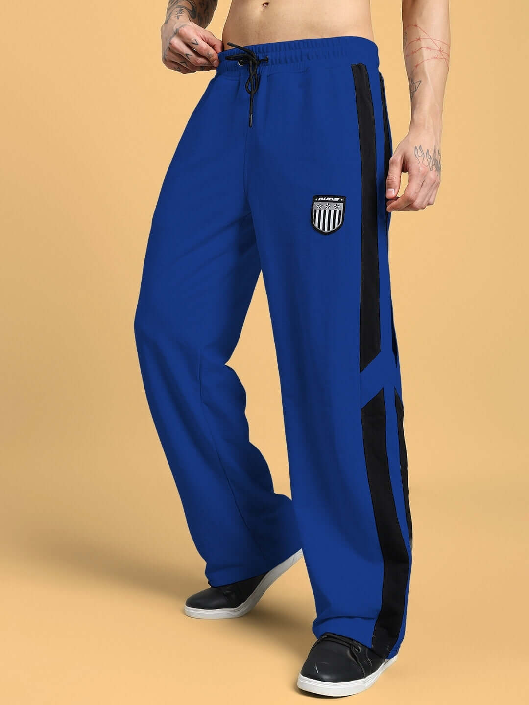 Men's blue joggers with black stripe, available in custom sizes, handmade by DUDS tailors, ideal for comfortable and stylish wear.