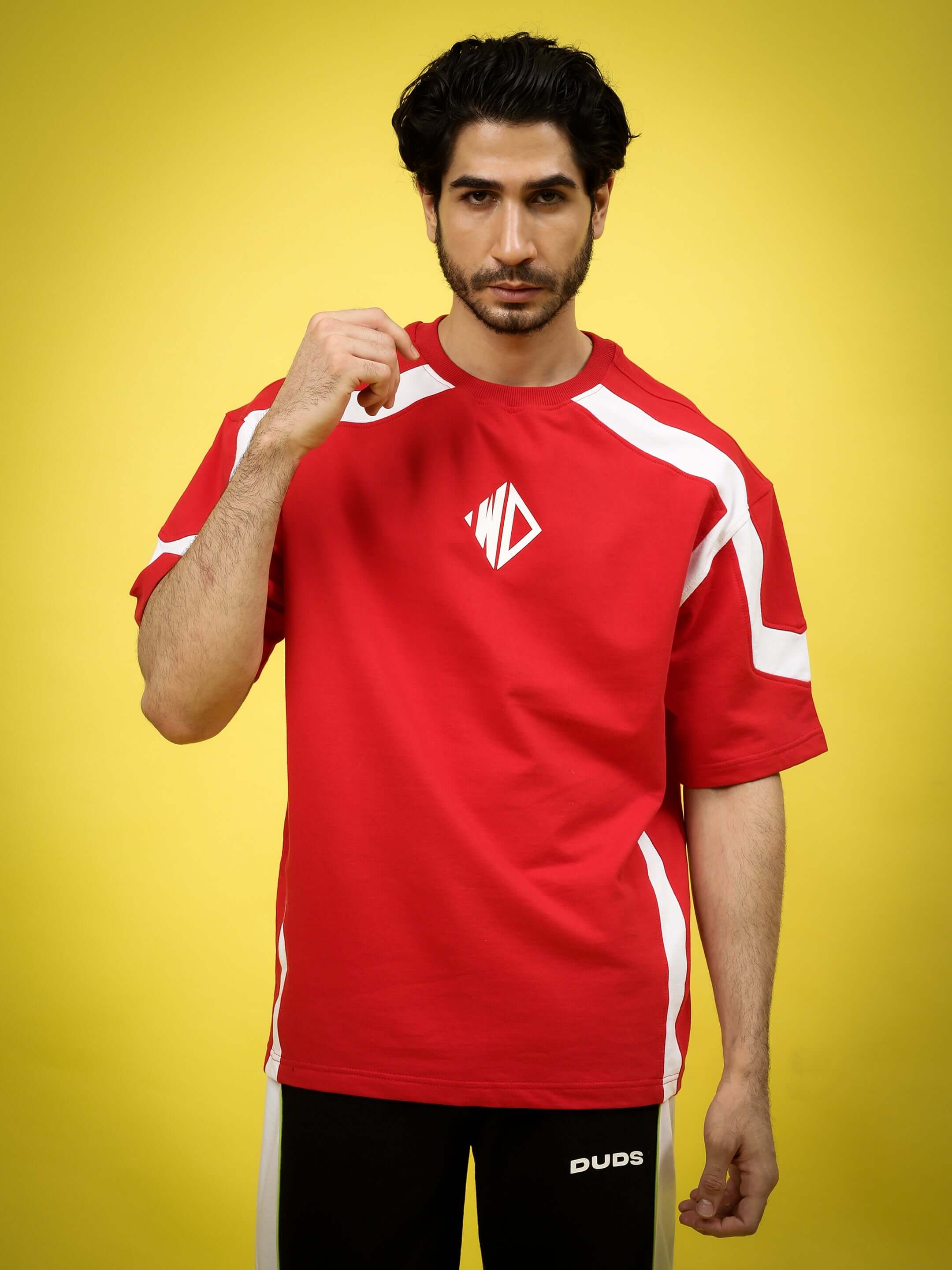Model wearing rugby over-sized red and white t-shirt made from premium cotton French terry fabric, on a yellow background.