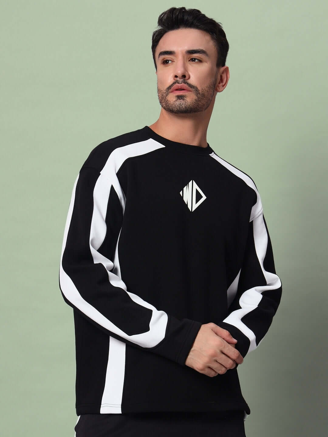 Man wearing RUGBY OVERSIZED FLEECE SWEATSHIRT BLACK with white stripes, showing relaxed fit and modern athletic style.