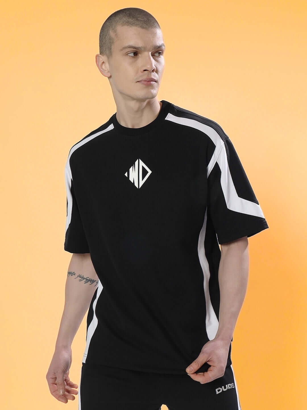 Model wearing rugby over-sized black and white t-shirt made from premium cotton and elastane, perfect for comfort and style.