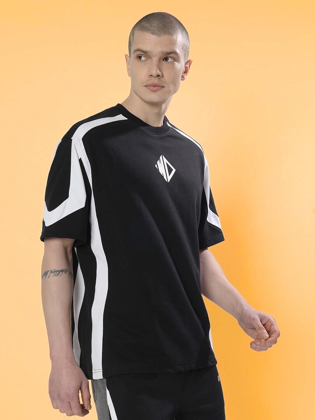 Black and white rugby over-sized T-shirt made from premium cotton fabric, modeled by a person against an orange background.