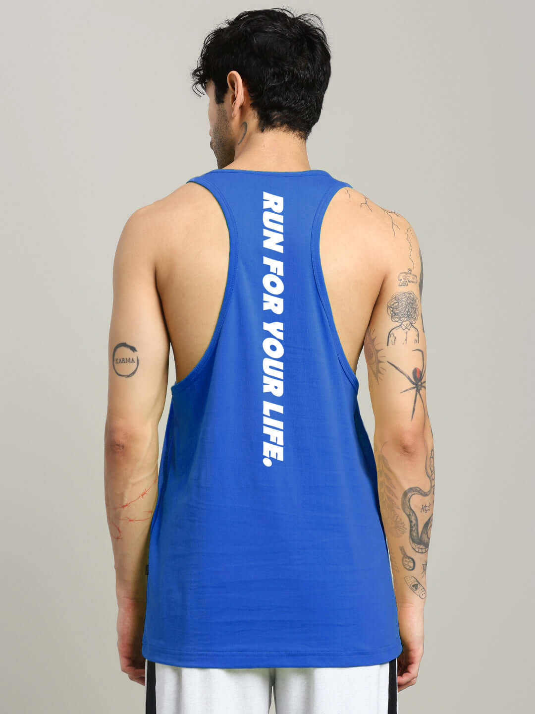 Alt Tag: Back view of man wearing RUN FOR LIFE SLEEVELESS GYM T-SHIRT BLUE with motivational print, ideal for athletes.