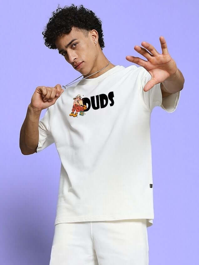 Young man wearing SAFARI PRINTED OVERSIZED T-SHIRT OFF-WHITE with a bold graphic design on a light purple background.