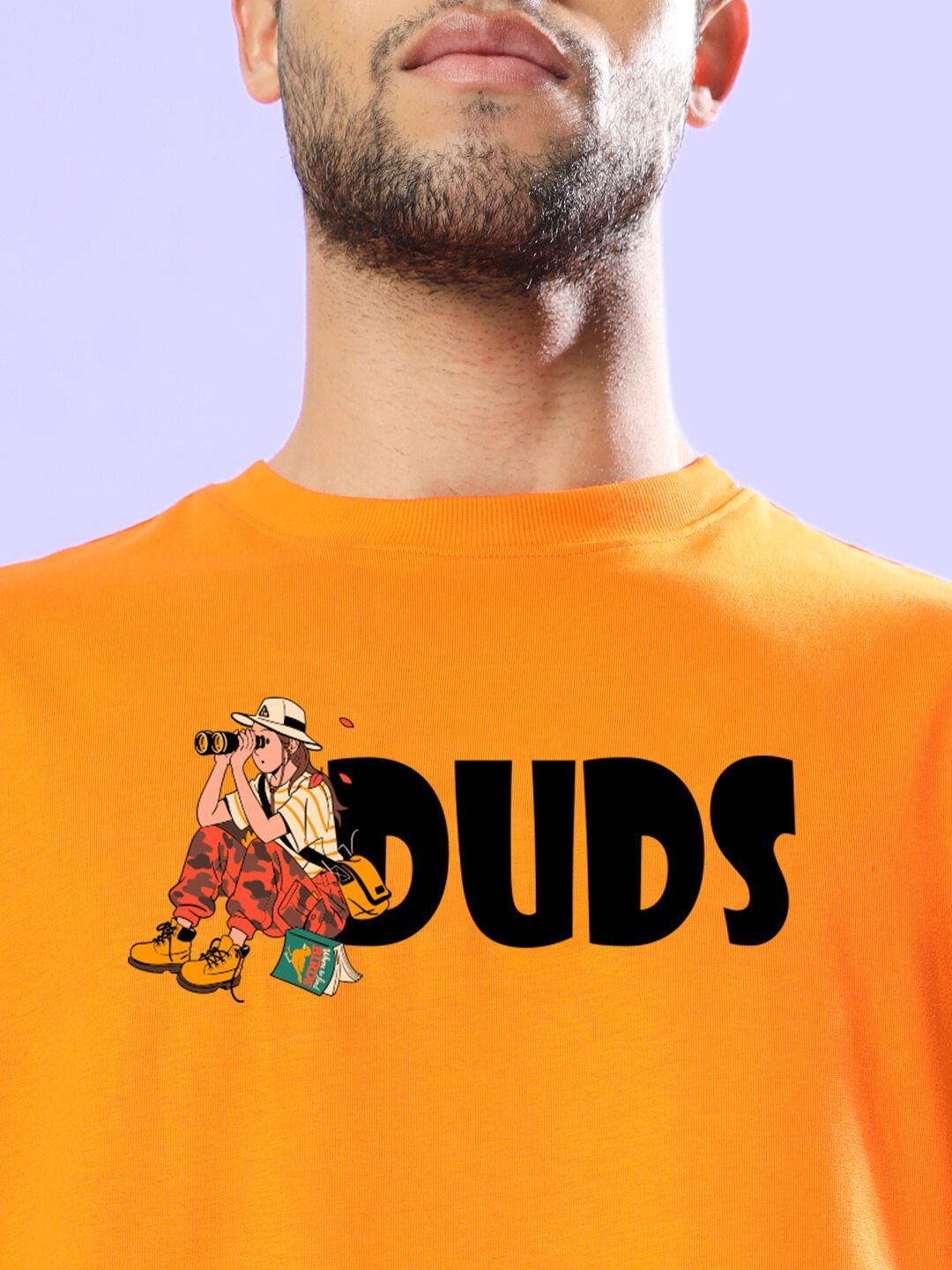 Model wearing SAFARI PRINTED OVERSIZED T-SHIRT ORANGE with graphic design.