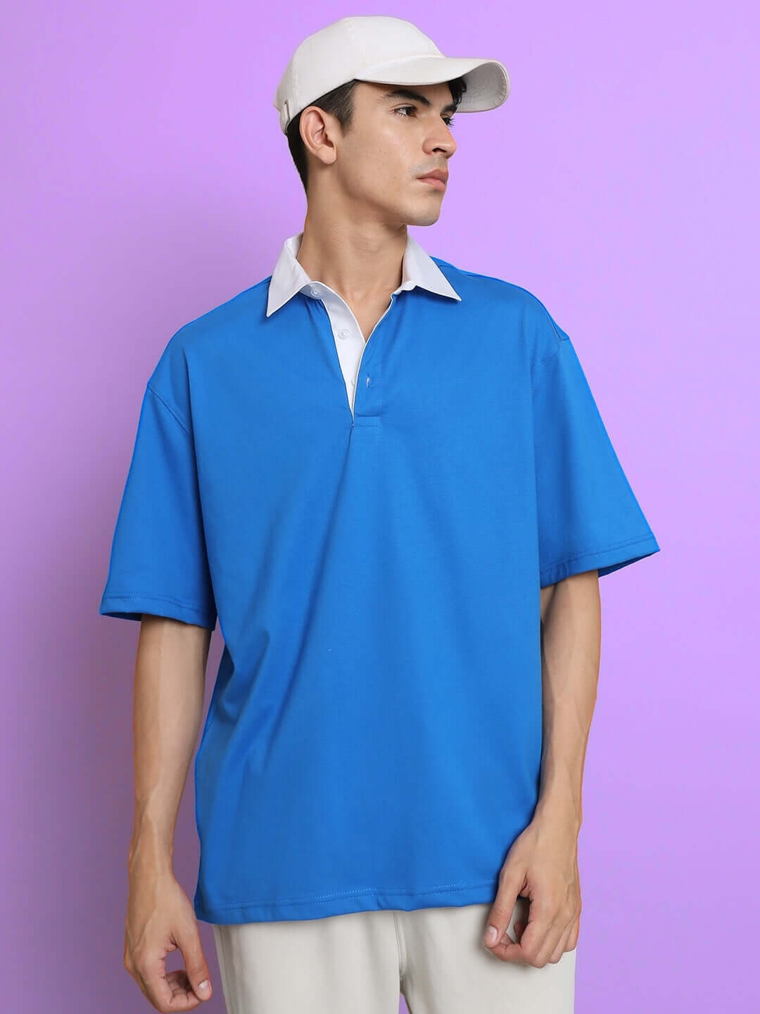 Model wearing oversized SAGOL Polo T-shirt in royal blue, half sleeves, made from premium 100% cotton fabric, perfect for all-day comfort.