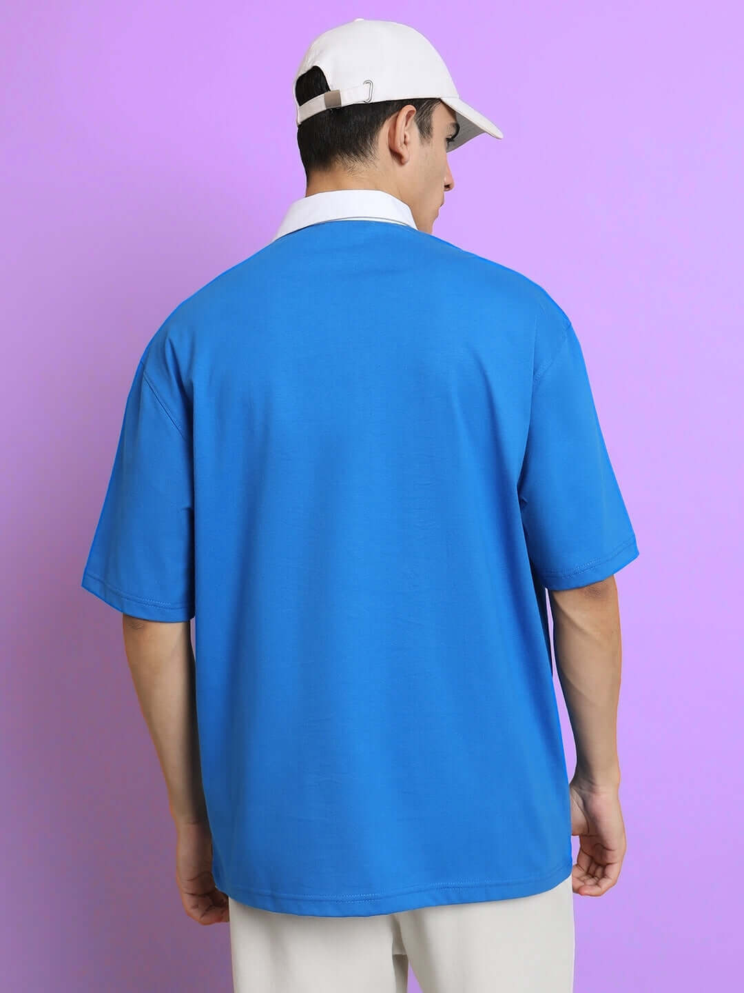 Model wearing SAGOL Oversized Royal Blue Polo T-Shirt, half sleeves, 100% cotton, premium fabric, back view, comfortable fit, stylish wear.