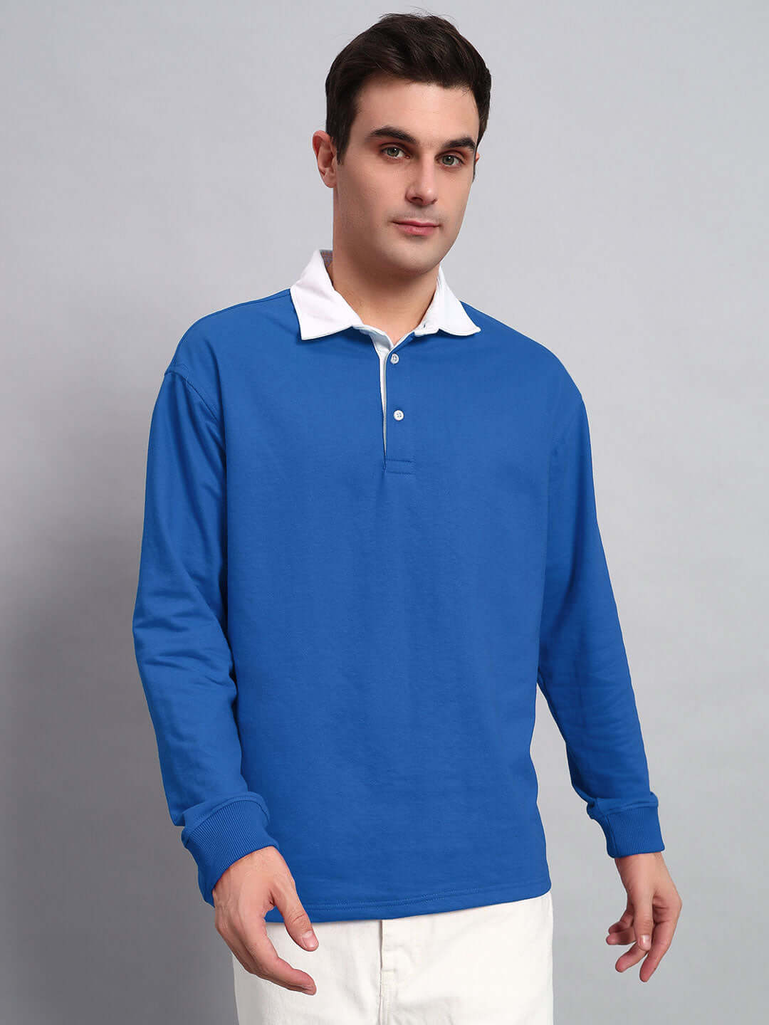 Man wearing a SAGOL POLO oversized sweatshirt in royal blue, made from premium cotton fabric, featuring a white collar.