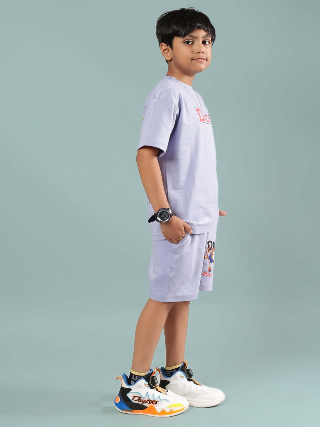 Child wearing SAMMY CO-ORD FOR BOYS & GIRLS LAVENDER with colorful sneakers, displaying comfort and style. Available for custom fit.