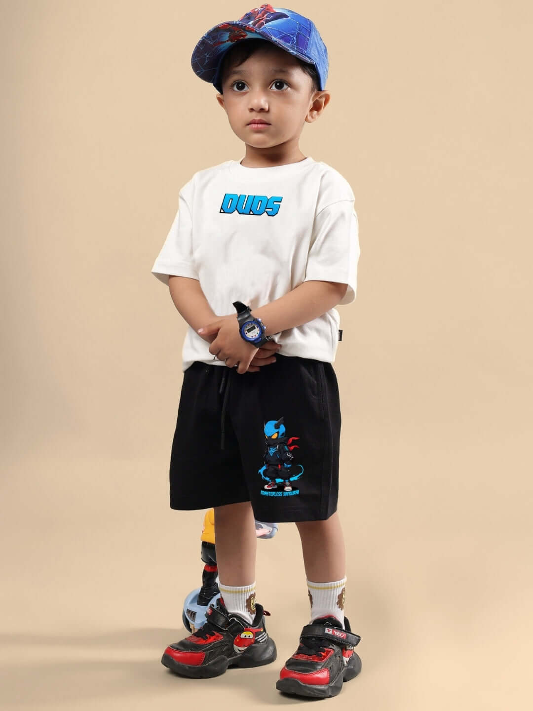 Child wearing SAMURAI PRINTED CO-ORD FOR BOYS & GIRLS OFF WHITE BLACK, featuring off-white tee and black shorts with Samurai print.