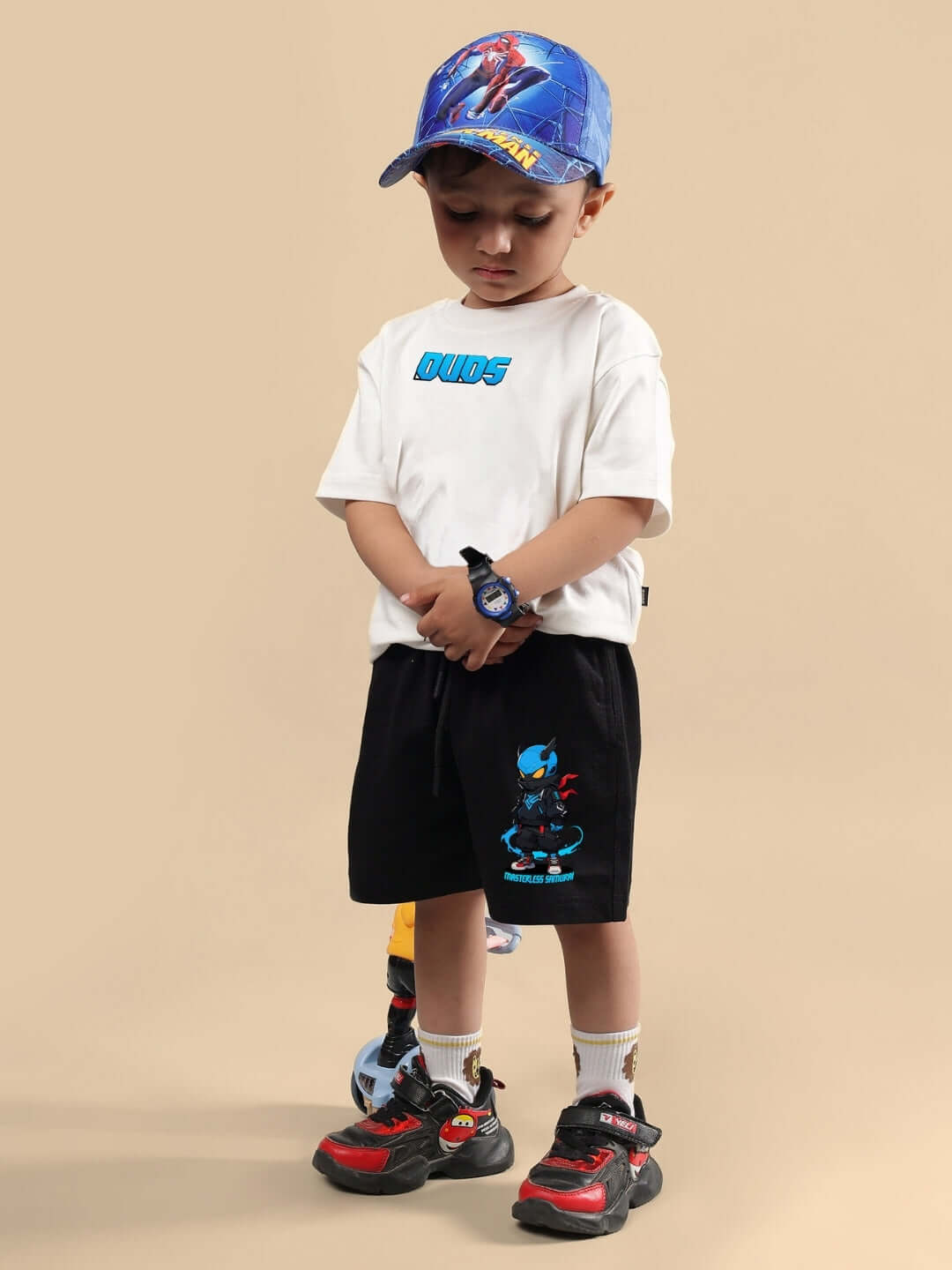 Child wearing Samurai Printed Co-Ord for Boys & Girls Off White Black with graphic shorts and sneakers.