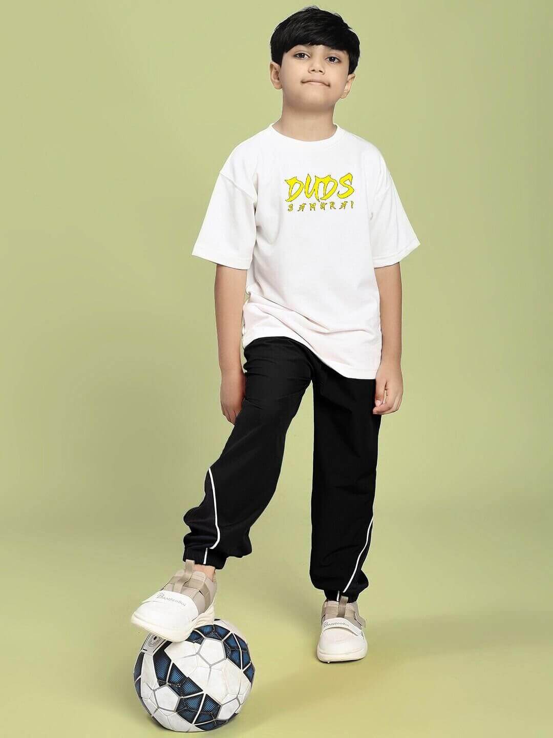 Boy wearing SAMURAI SOUL PRINTED T-SHIRT FOR BOYS AND GIRLS WHITE with a soccer ball at his feet.