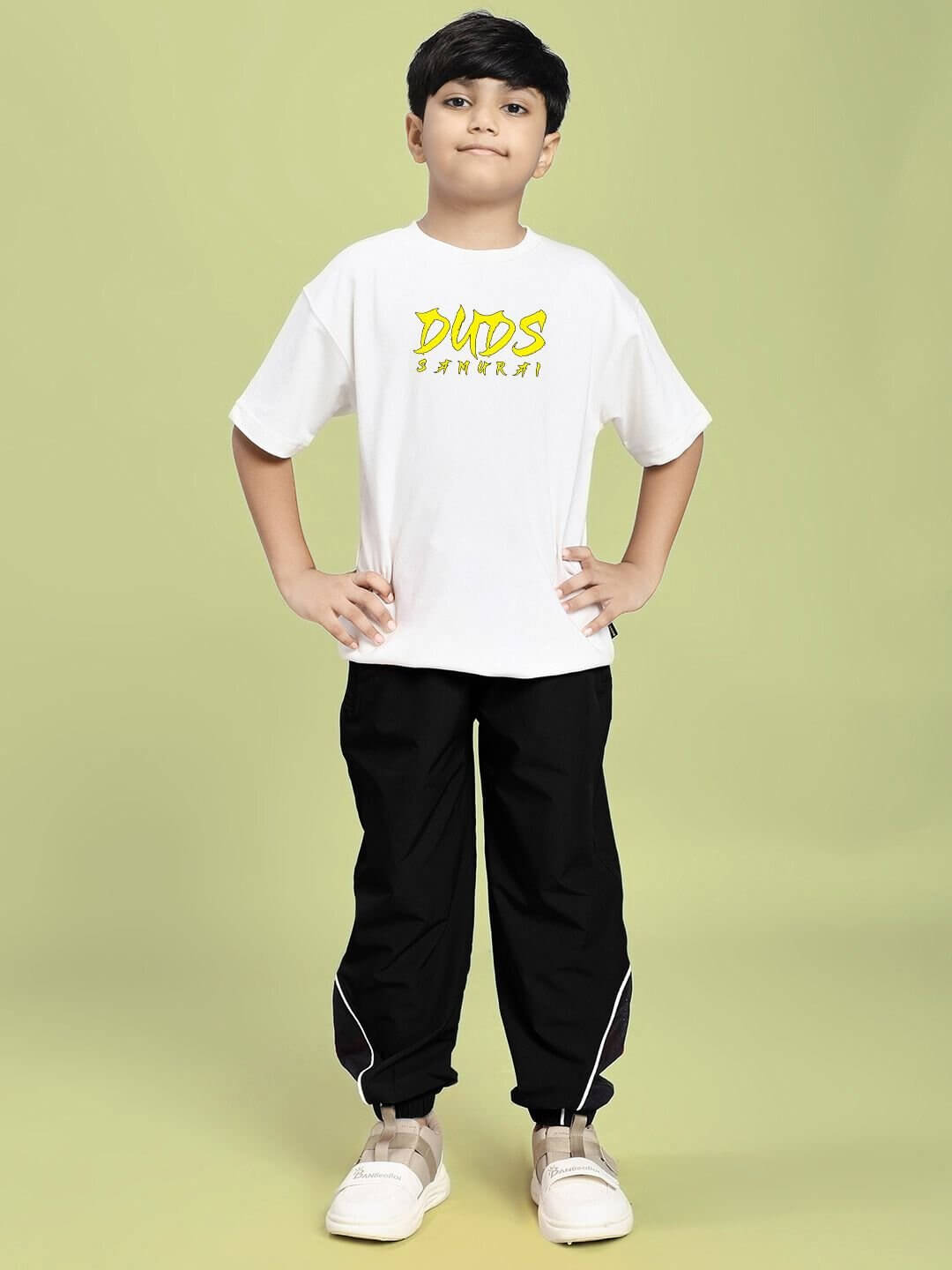 Child wearing SAMURAI SOUL PRINTED CO-ORD FOR BOYS AND GIRLS WHITE BLACK featuring a white t-shirt and black pants.