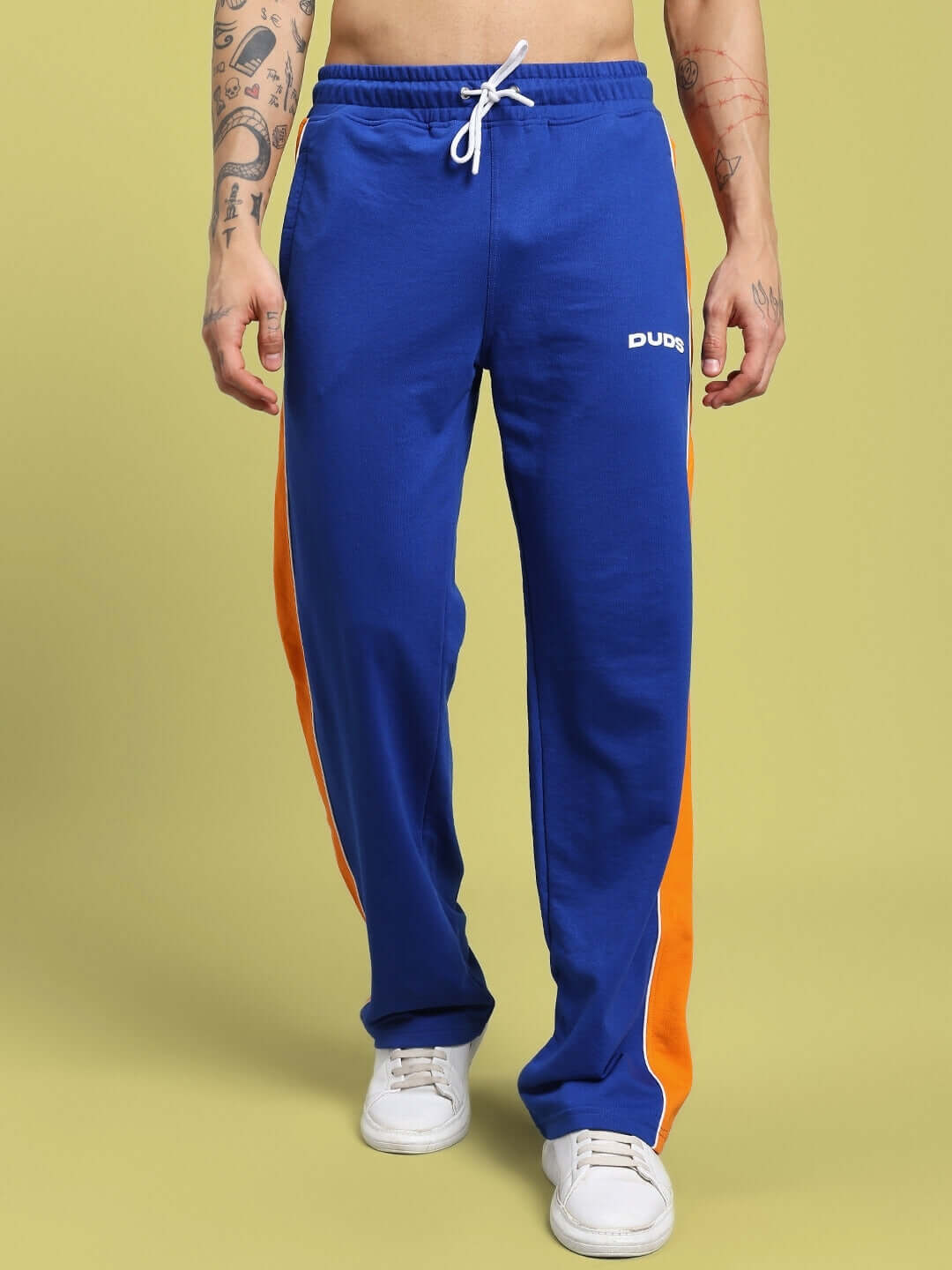 Man wearing SANFORD STRIPE JOGGERS BLUE with orange side stripes, showcasing fitness fashion style.