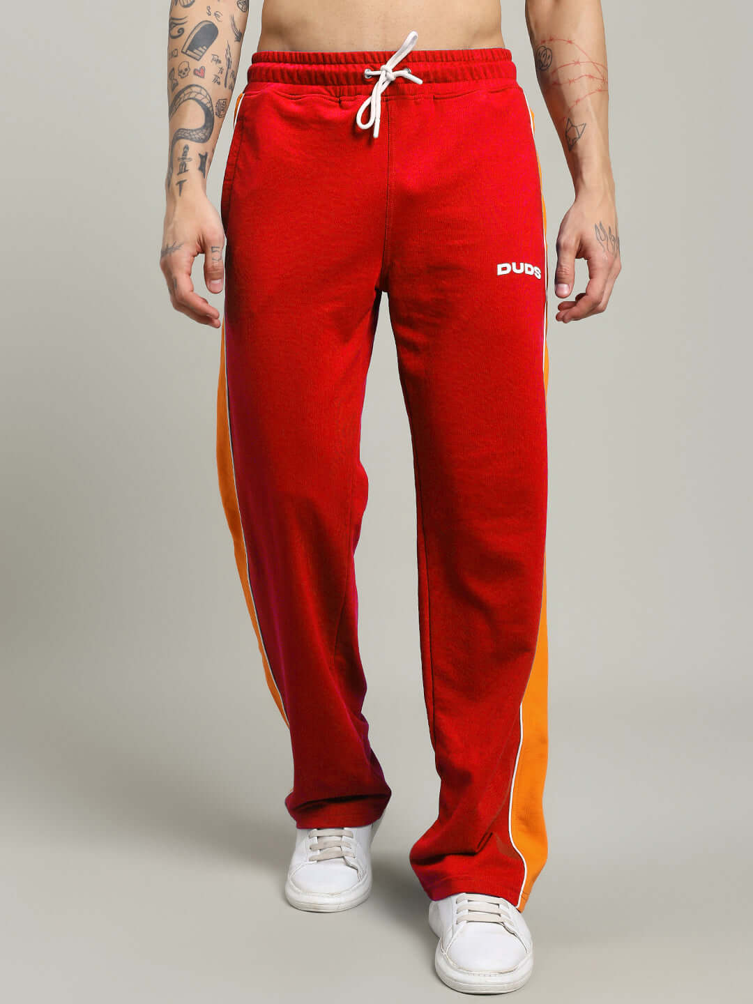 Red Sanford stripe joggers by DUDS with customizable fit and made-to-order shipping, featuring orange side stripes and drawstring waist.