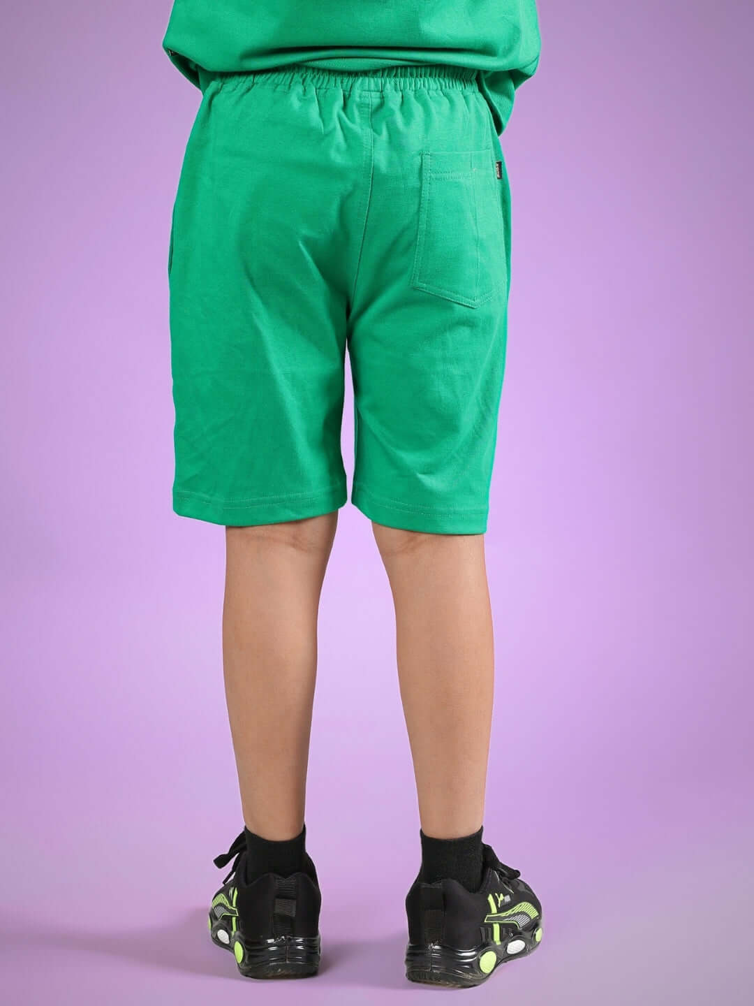 Child wearing SATORU SHORTS FOR BOYS & GIRLS GREEN, made with care by DUDS tailors.