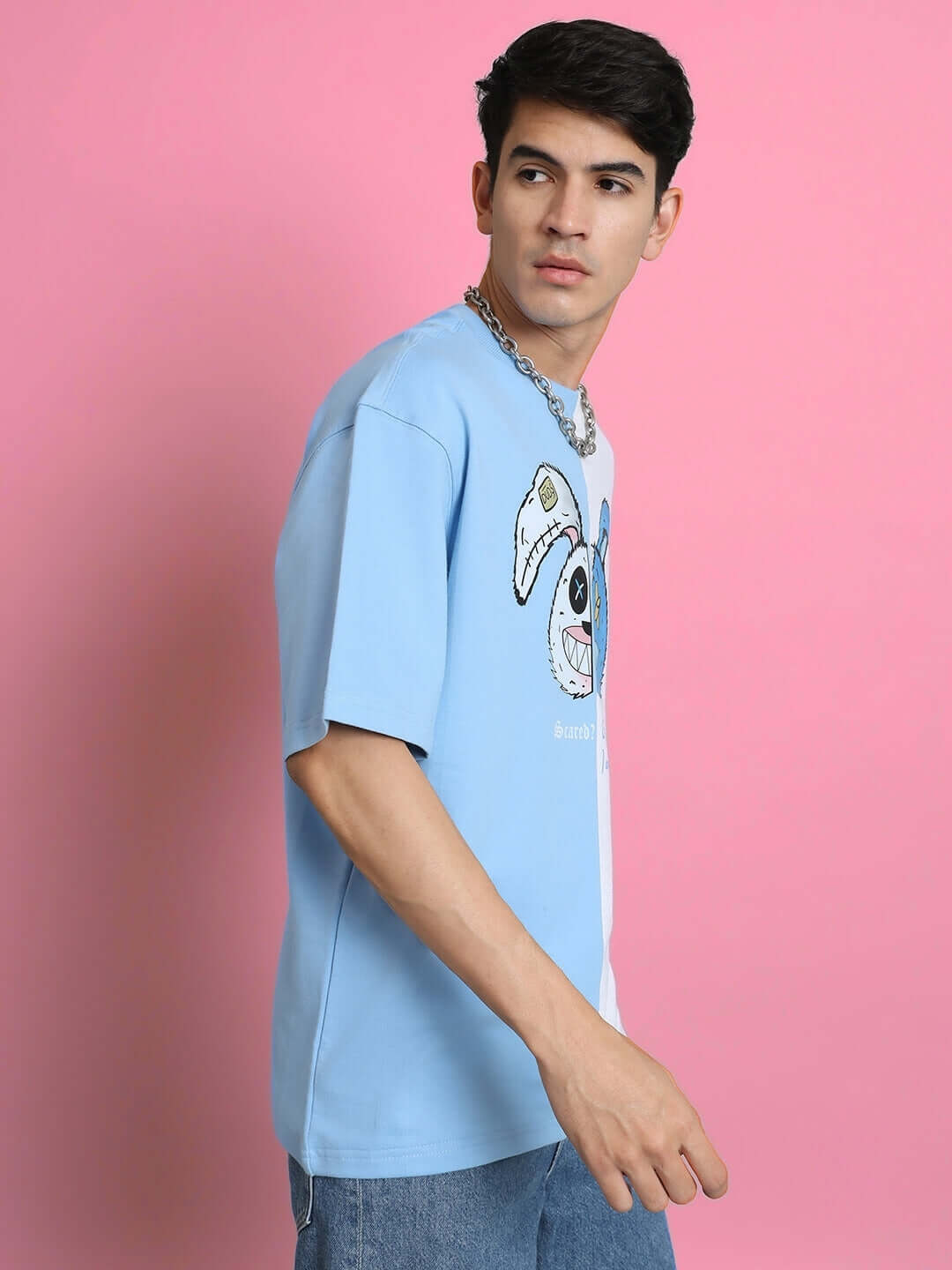 Model wearing SCARED TEDDY oversized T-shirt in sky blue-white, crafted from premium cotton French terry with graphic design on front.