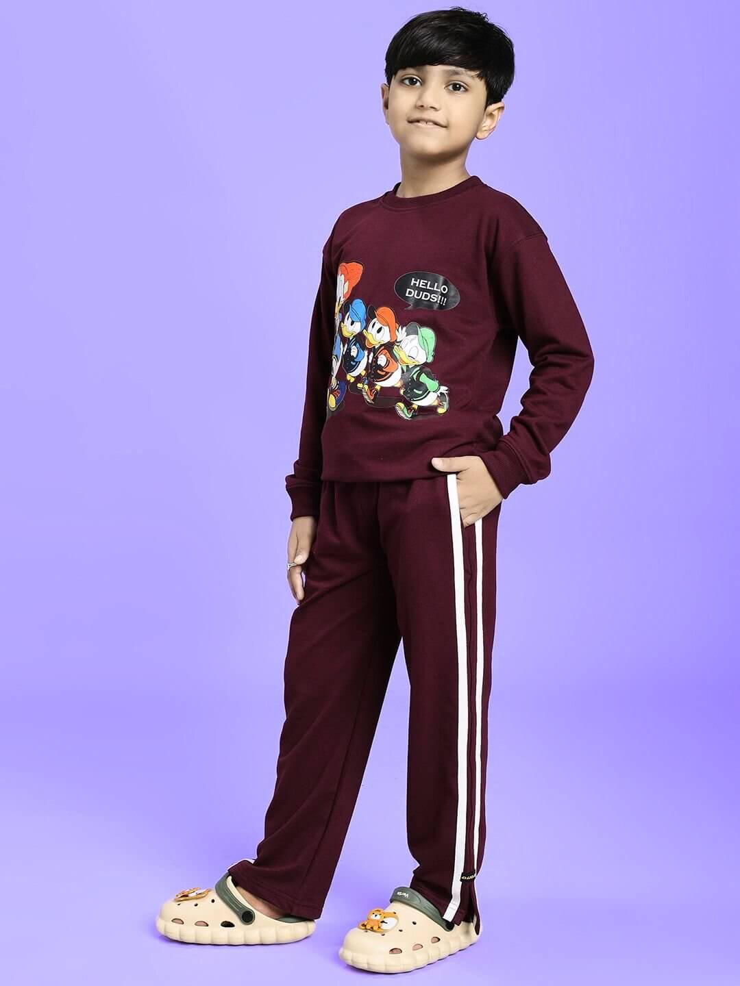 Child wearing SCHOOL DAYS CO-ORD FOR BOYS GIRLS MAROON outfit with playful design on a purple background.
