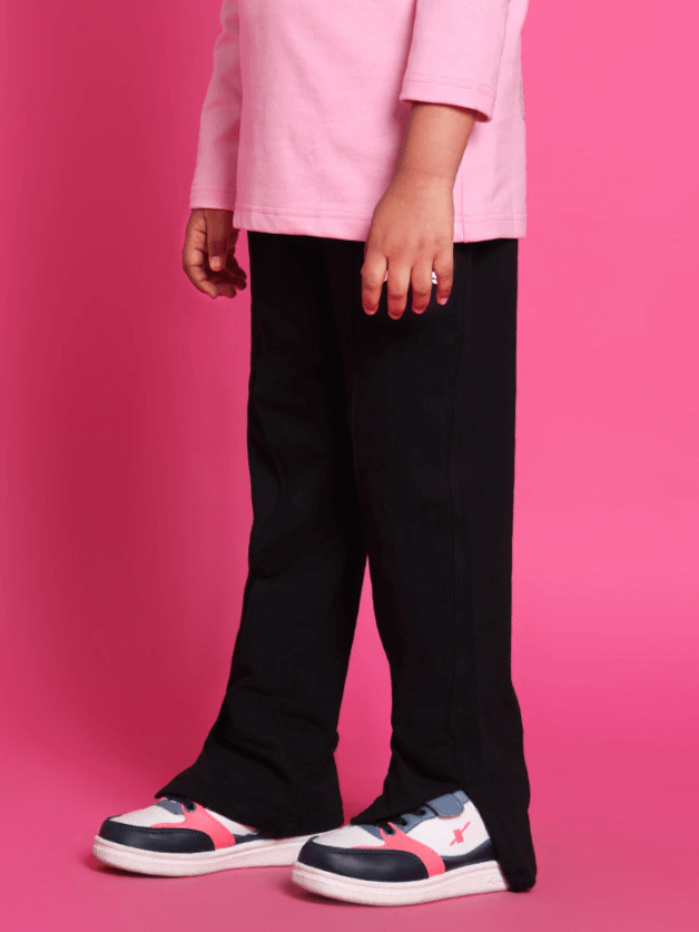 Kid wearing black scooter jogger pants with pink sneakers, suitable for boys and girls, made to order by DUDS.