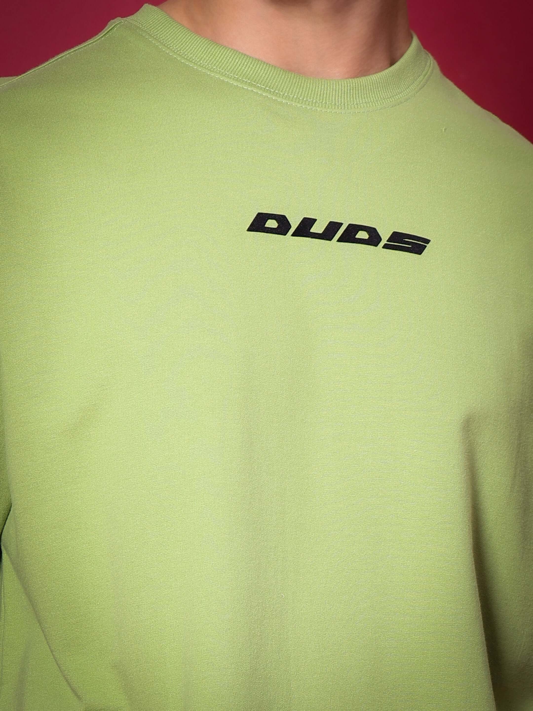SCORPIO oversized pista green t-shirt with DUDS logo in premium cotton French terry. Bio-washed for softness.