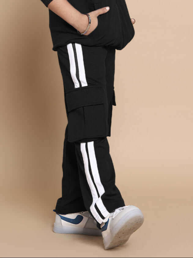 Child wearing black SCOTIA co-ord set with white stripes, 100% cotton terry fabric. Ideal for machine wash. Stylish unisex outfit, India.