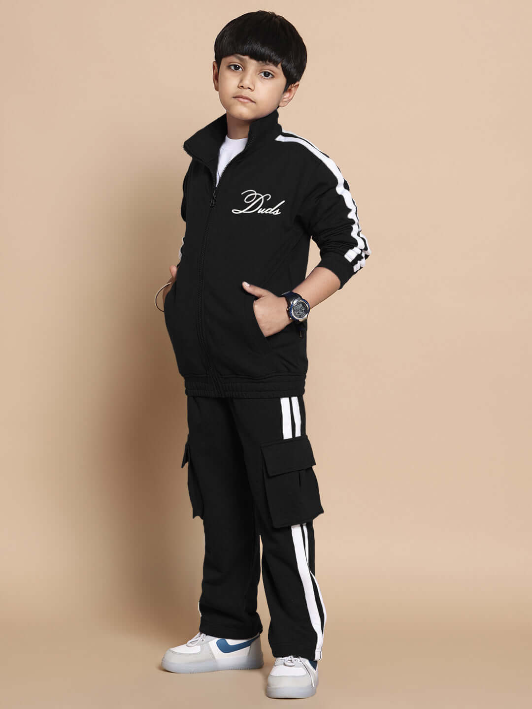 Child wearing black SCOTIA CO-ORD set with white stripes, made of premium cotton terry fabric from India, perfect for boys and girls.