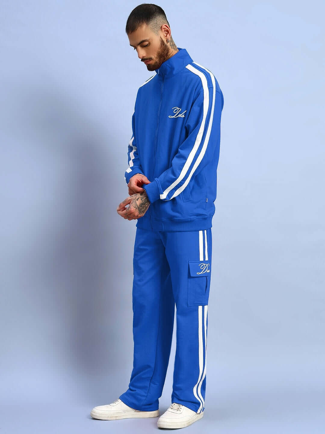 Man wearing a royal blue SCOTIA jacket with white stripes, designed by experienced tailors, showcasing the made-to-order fashion.
