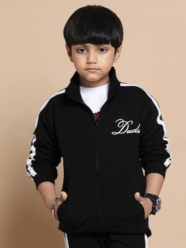 Boy wearing black Scotia Jacket by DUDS, featuring a comfortable fit, made-to-order craftsmanship, suitable for boys and girls.