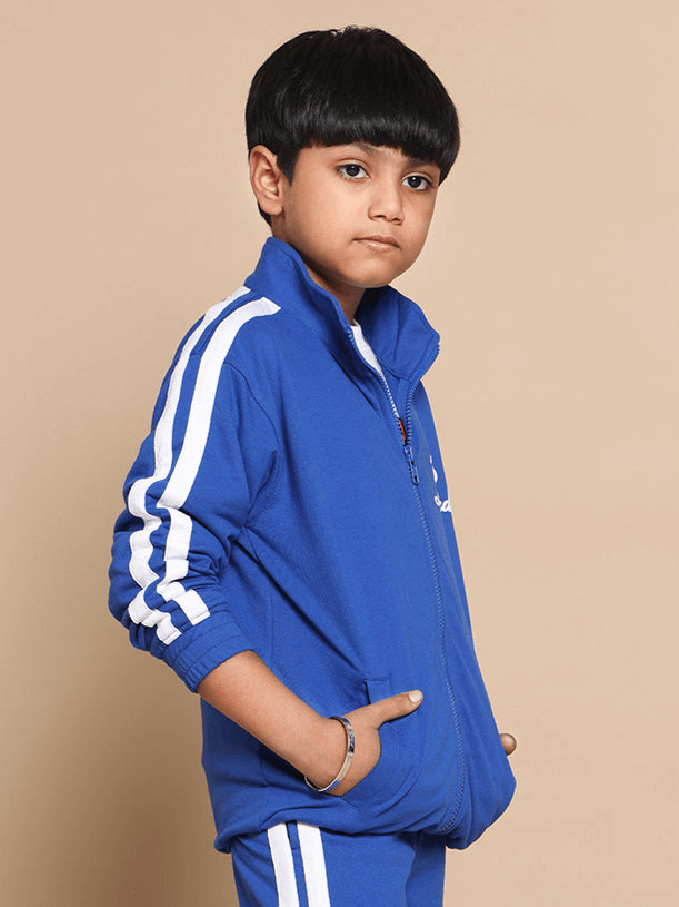 Child wearing royal blue Scotia jacket with white stripes, designed for boys and girls, made by DUDS; available with custom fit option.