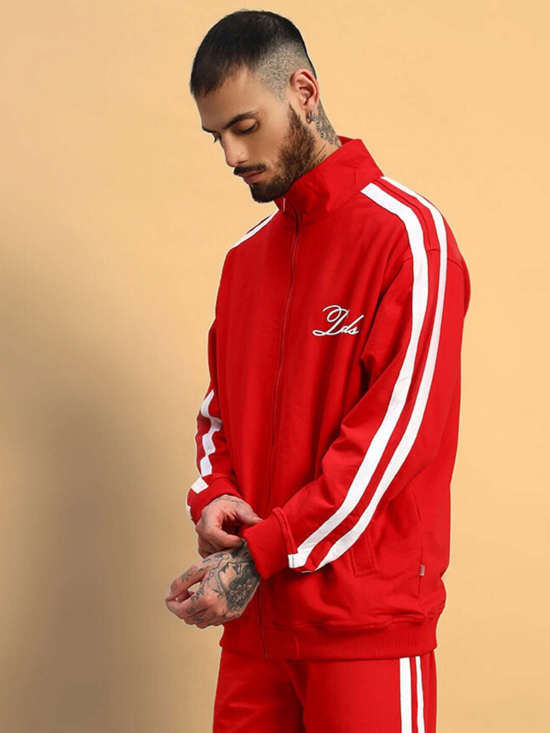 Man wearing red SCOTIA jacket with white stripes, embroidered with DUDS logo.