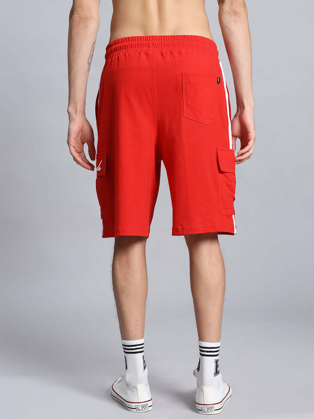 Man wearing SCOTIA REGULAR FIT COTTON SHORTS RED, showcasing back pocket and sporty style.