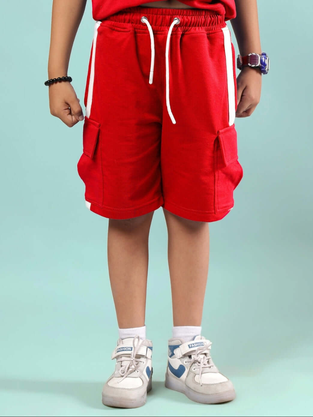 Child wearing SCOTIA SHORTS FOR BOYS & GIRLS RED, showcasing comfortable and stylish design.