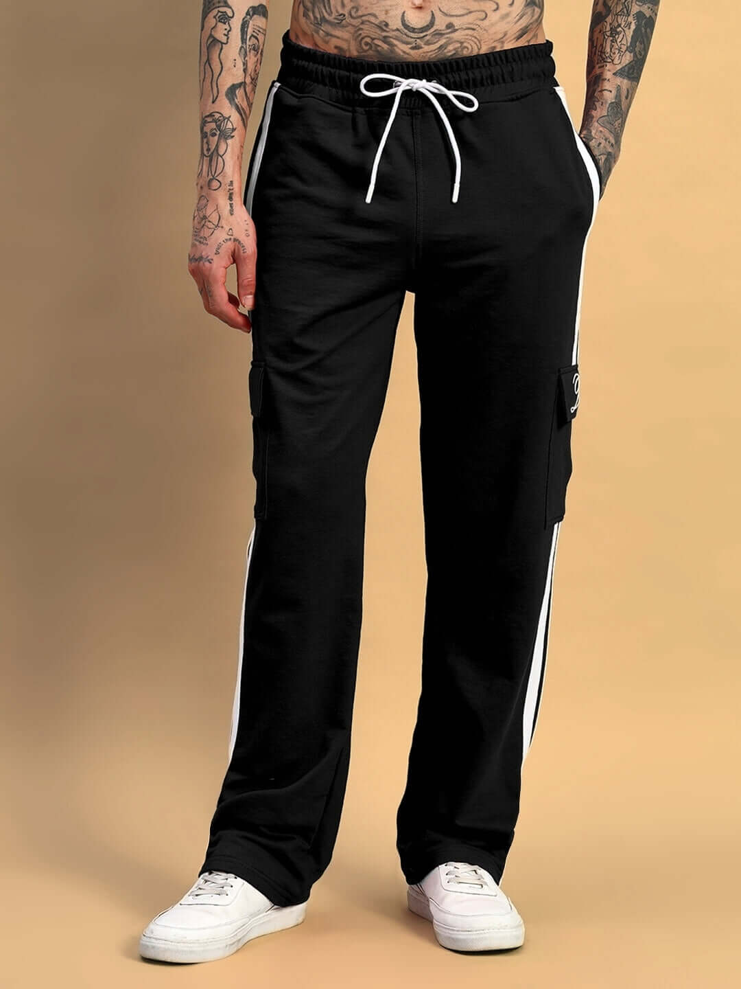 Man wearing black Scotia Stripe Joggers with white stripes and sneakers showcasing comfortable fit and casual style.