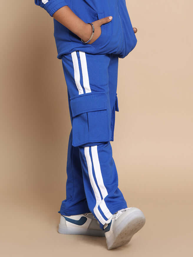 Child wearing royal blue Scotia Stripe Joggers with white side stripes and sneakers, showcasing comfortable and stylish kids' fashion.