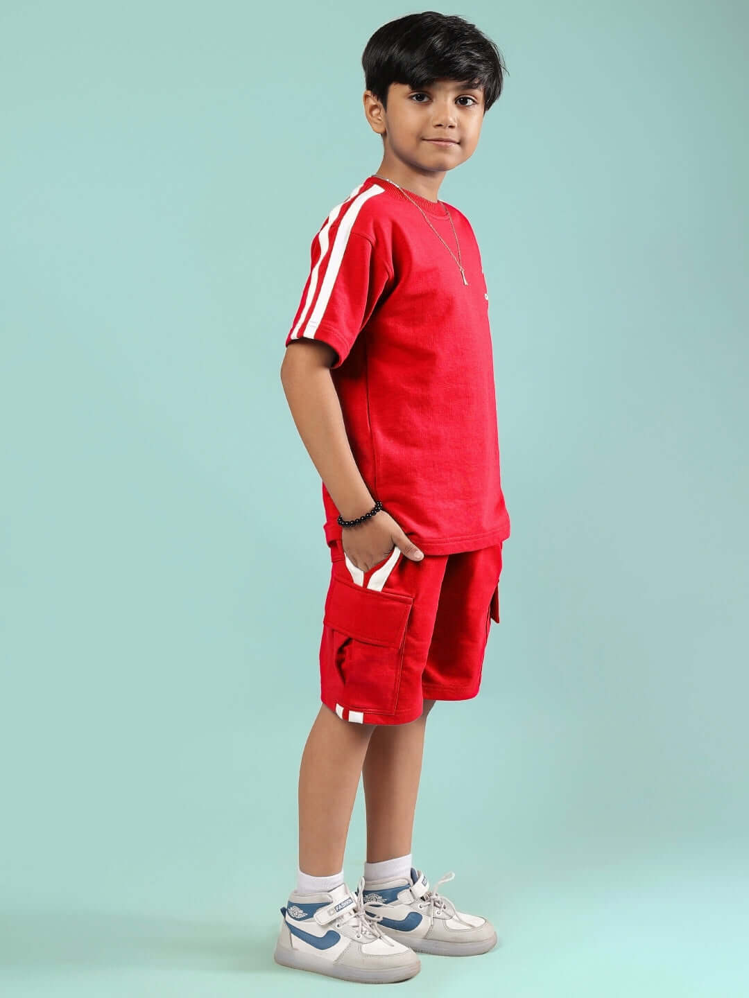 Child wearing Scotia Summer Co-Ord for Boys & Girls Red, featuring a stylish red cotton outfit perfect for summer outings and playtime.