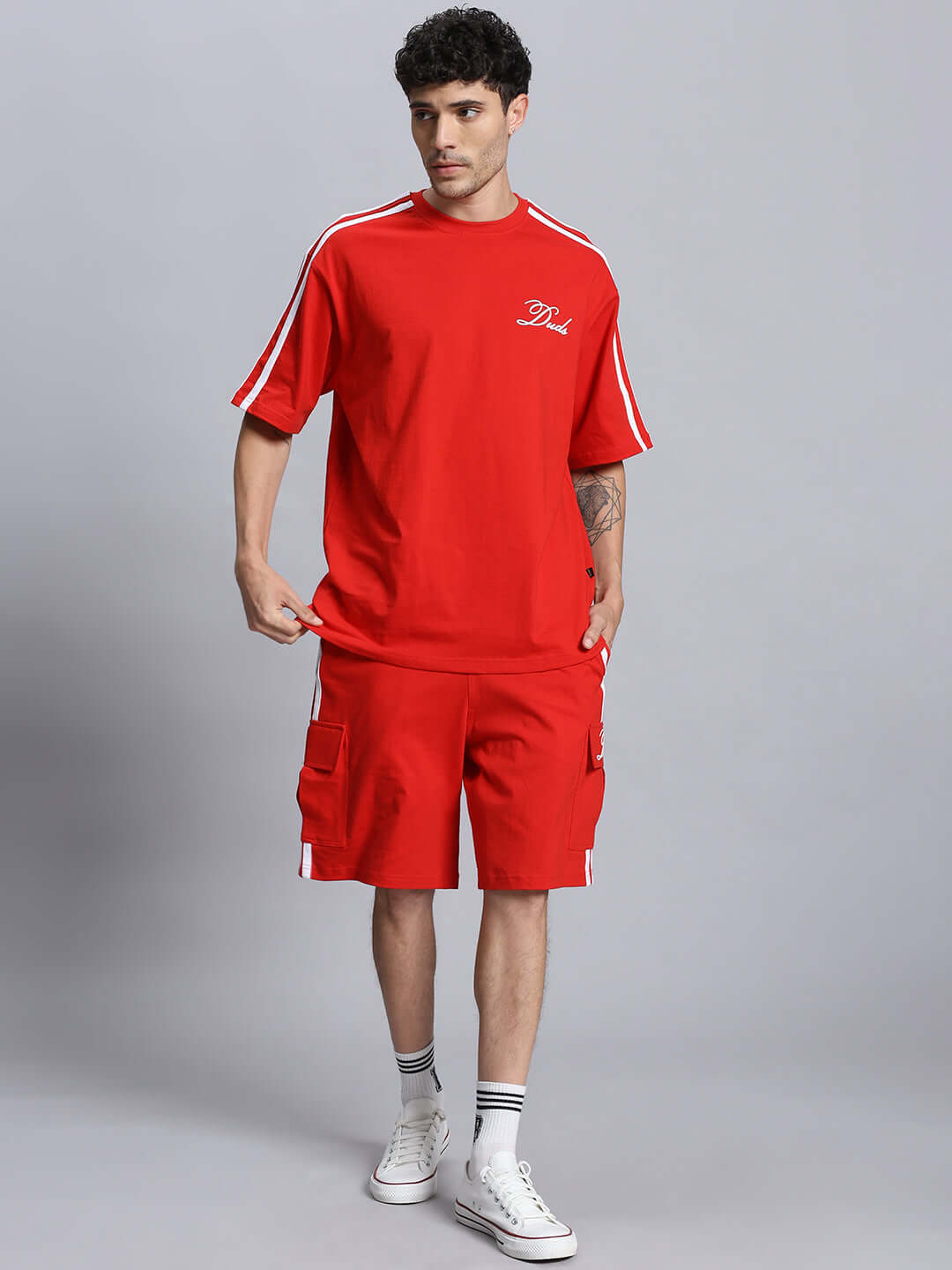 Model wearing red SCOTIA SUMMER CO-ORD SET made of premium cotton French terry, featuring short sleeves and cargo shorts, perfect for casual wear.